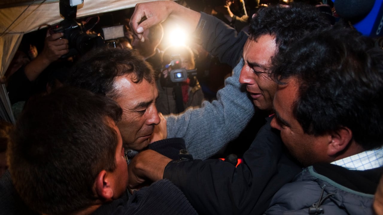 COPIAPO, CHILE - OCTOBER 13: Alfonso Avalos (L) father of Florencio Avalos, one of the 33 miners trapped 700 meters underground for two months in the San Jose Copper-Gold mine, reacts after his son is brought safely to the surface just after the start of the rescue operation on October 13, 2010 in Copiapo, Chile. (Photo by Vicente Tapia/LatinContent via Getty Images)