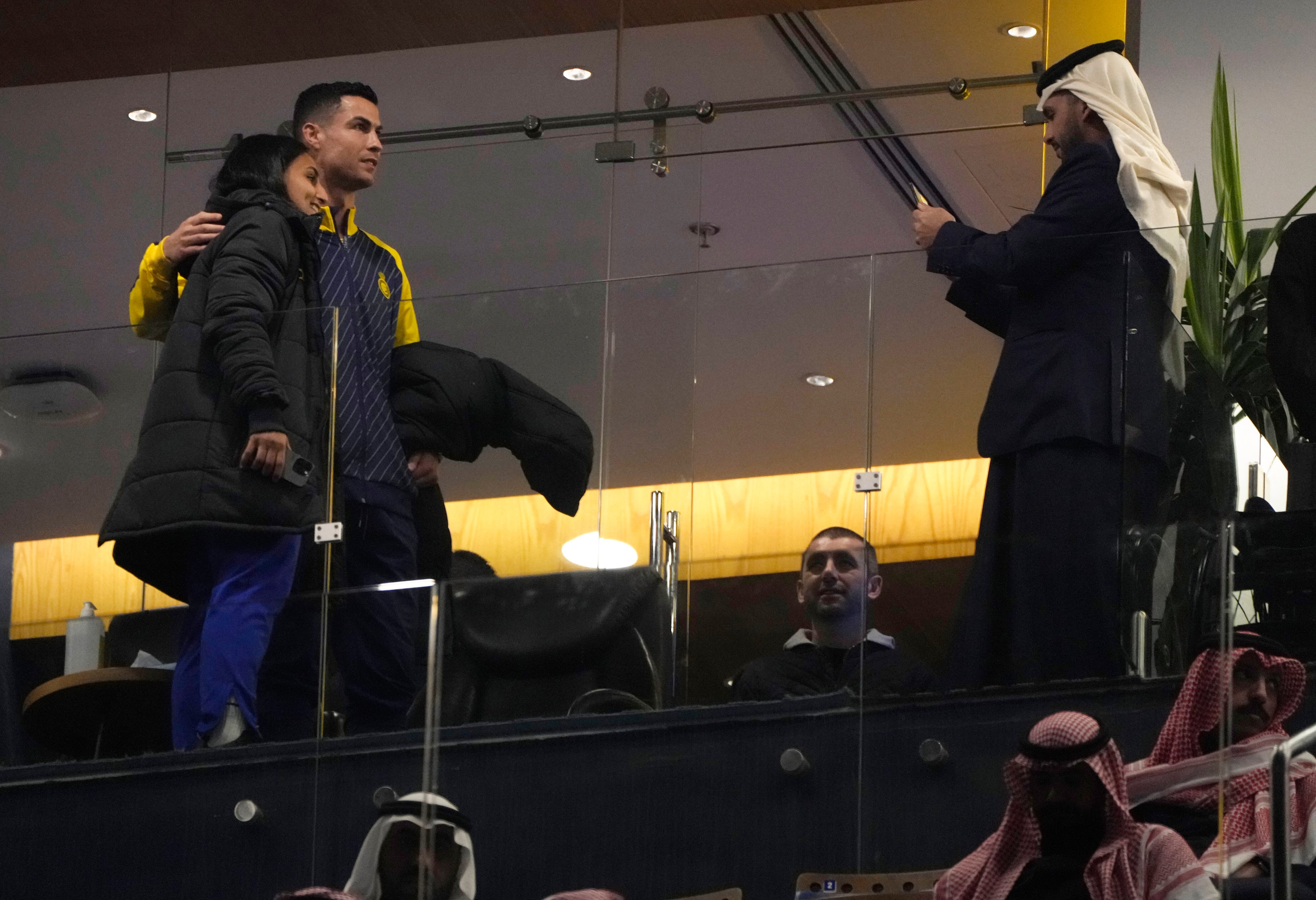 Cristiano Ronaldo, a new member of Al Nassr soccer club, poses with a fan he attends his team match against Al Tai on the Saudi League at Marsool Park in Riyadh, Saudi Arabia, Friday, Jan. 6, 2023. Ronaldo, who has won five Ballon d'Ors awards for the best soccer player in the world and five Champions League titles, will play outside of Europe for the first time in his storied career. (AP Photo/Amr Nabil)