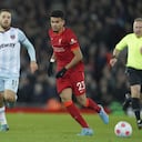Liverpool's Luis Diaz, center, and West Ham's Nikola Vlasic, left, vie for the ball during the English Premier League soccer match between Liverpool and West Ham United at Anfield stadium in Liverpool, England, Saturday, March 5, 2022. (AP Photo/Jon Super)