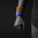 Power, Protest and Expression for LGBTQ, Rights Concept. Closeup of Fist and Rainbow Wrist Strap. Angry, Ready to Punch. Cropped and Selective Focus
