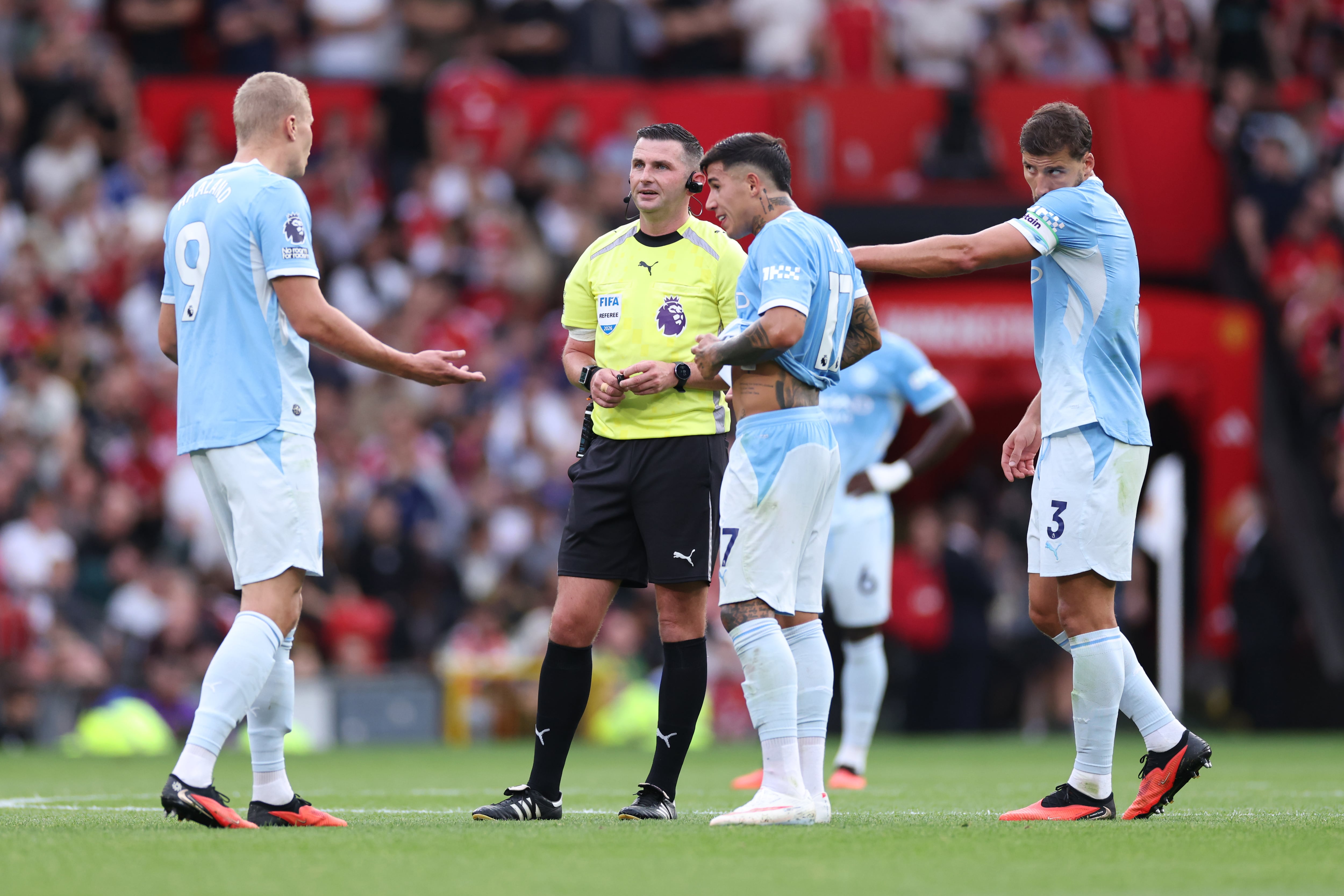 MANCHESTER, ENGLAND - SEPTEMBER 13: Erling Haaland of Manchester City speaks with Referee Michael Oliver as a VAR check is performed after his goal is initially ruled offside, only to be overturned during the Premier League 2026/27 match between Manchester United and Manchester City at Old Trafford on September 13, 2026 in Manchester, England. (Photo by Marc Atkins/Getty Images)