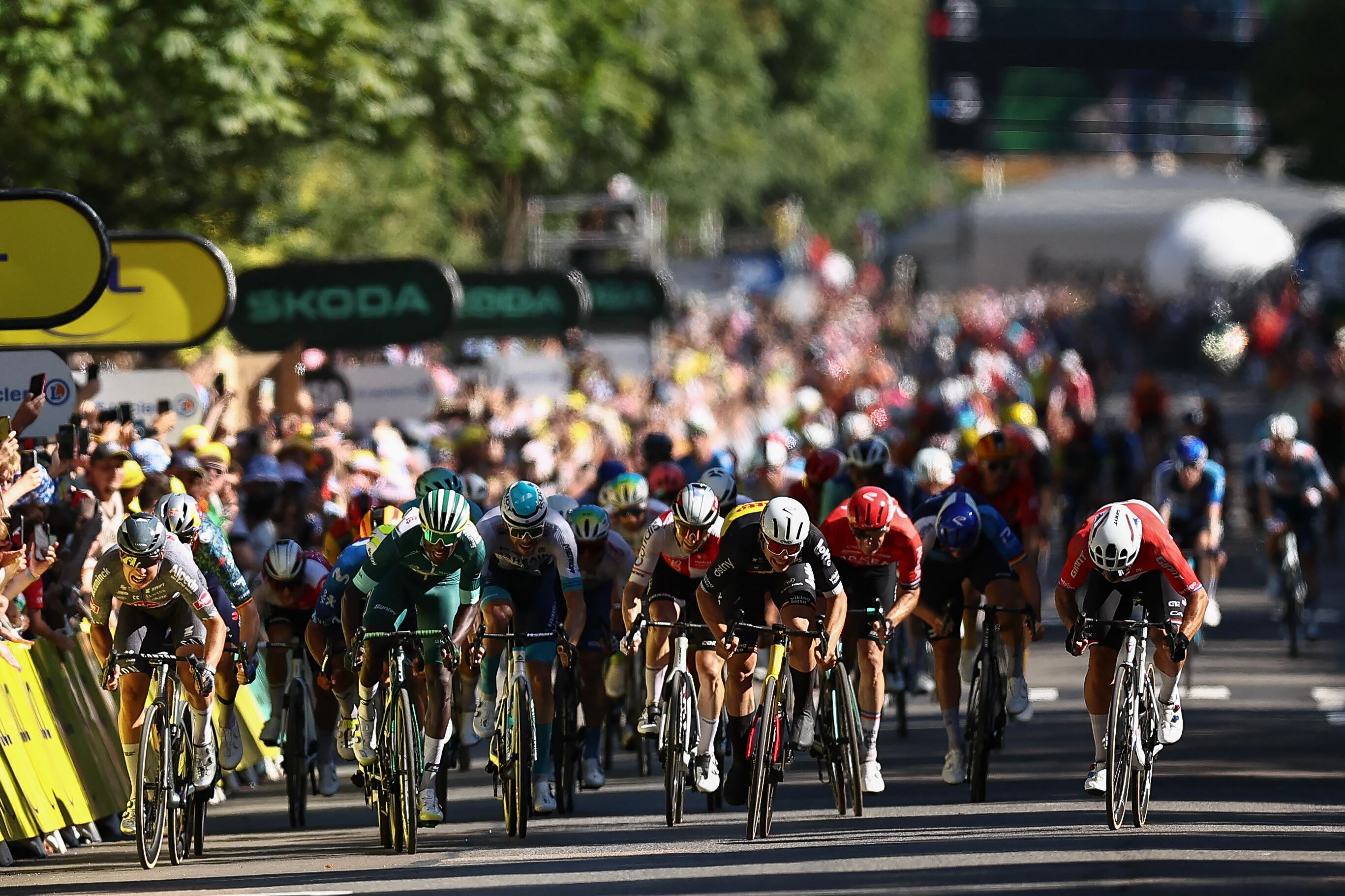 Team Jayco AlUla team's Dutch rider Dylan Groenewegen (R) sprints to the finish line to win ahead of second-placed Alpecin-Deceuninck team's Belgian rider Jasper Philipsen (L) and third-placed Intermarche - Wanty team's Eritrean rider Biniam Girmay (C) during the 6th stage of the 111th edition of the Tour de France cycling race, 163,5 km between Macon and Dijon, on July 4, 2024. (Photo by Anne-Christine POUJOULAT / AFP)
