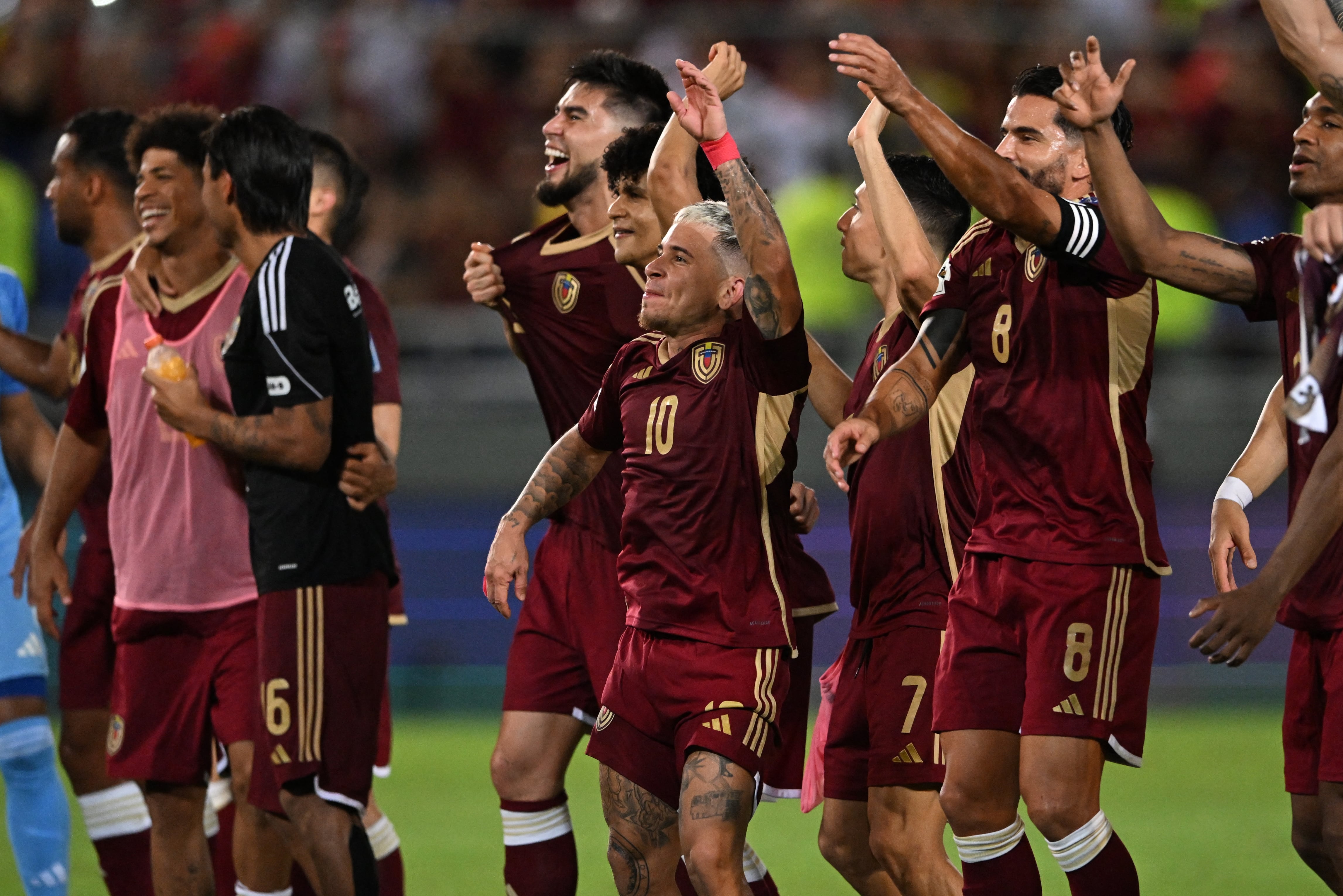 Venezuela's players celebrate after winning the 2026 FIFA World Cup South American qualifiers football match between Venezuela and Bolivia at the Monumental stadium in Maturin, state of Monagas, Venezuela, on June 6, 2025. (Photo by Juan BARRETO / AFP)