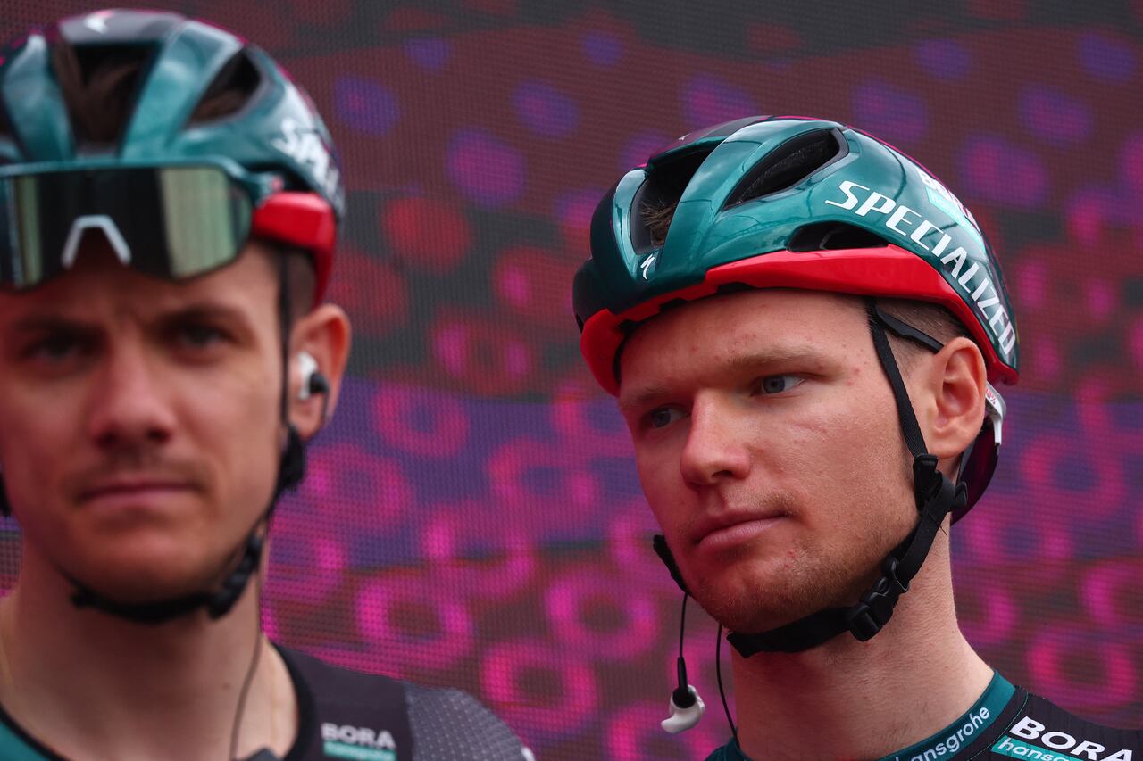 BORA - hansgrohe's Russian rider Aleksander Vlasov (R) stands on the podium during the teams' presentation, prior to the seventh stage of the Giro d'Italia 2023 cycling race, 218 km between Capua and Gran Sasso d'Italia, on May 12, 2023. (Photo by Luca Bettini / AFP)