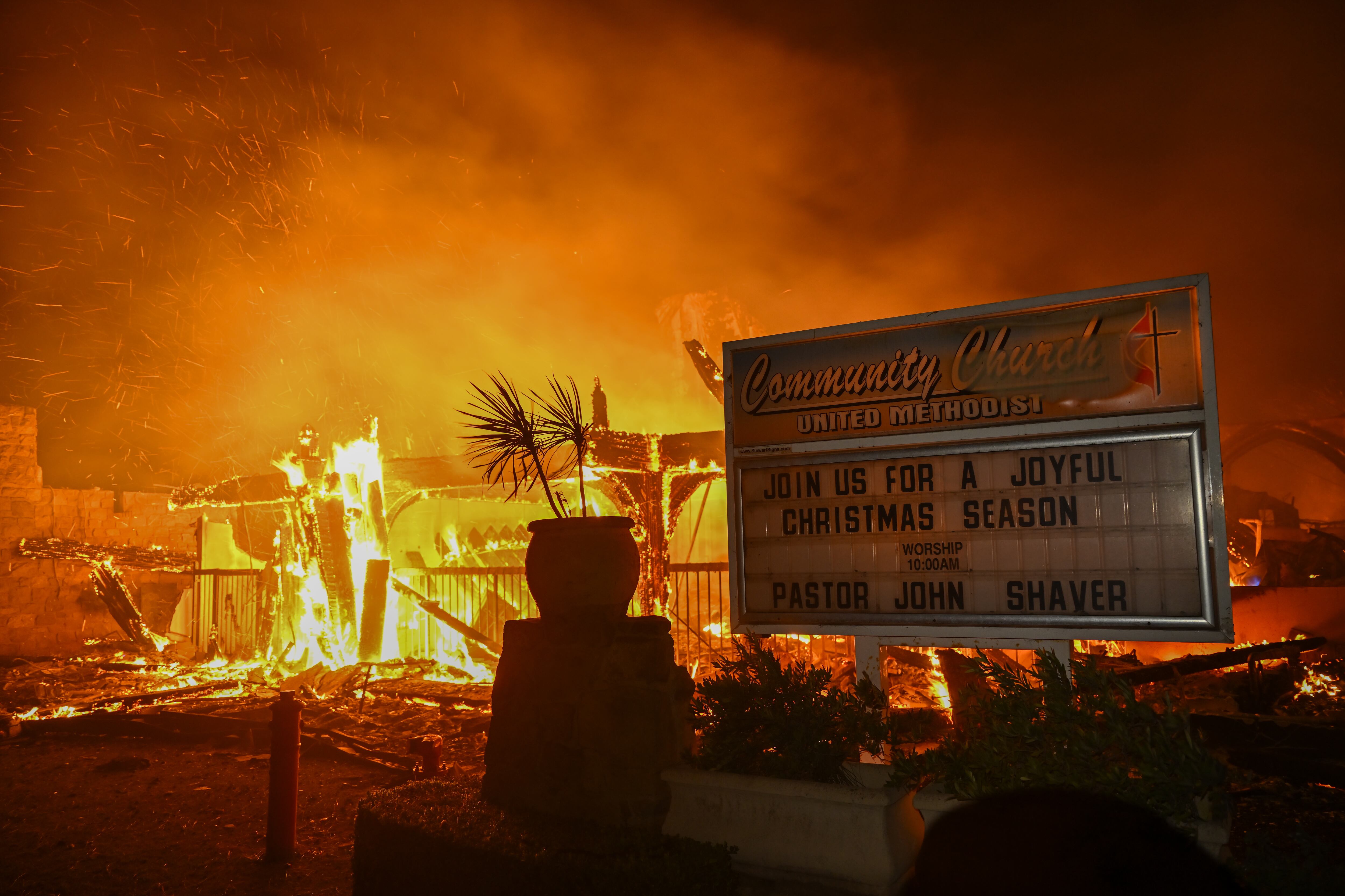 CALIFORNIA, UNITED STATES - JANUARY 8: A house in on fire as residents try to escape the site in Pacific Palisades, California, Los Angeles, United States on January 8, 2025. A fast-moving wildfire has forced 30,000 people to evacuate, with officials warning that worsening winds could further escalate the blaze. (Photo by Tayfun Coskun/Anadolu via Getty Images)