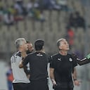 Egypt's head coach Carlos Queiroz, centre, looks up as referee Maguette Ndiaye of Senegal, right, shows a yellow card to one of his team officials during the African Cup of Nations 2022 quarter-final soccer match between Egypt and Morocco at the Ahmadou Ahidjo stadium in Yaounde, Cameroon, Sunday, Jan. 30, 2022. (AP Photo/Themba Hadebe)