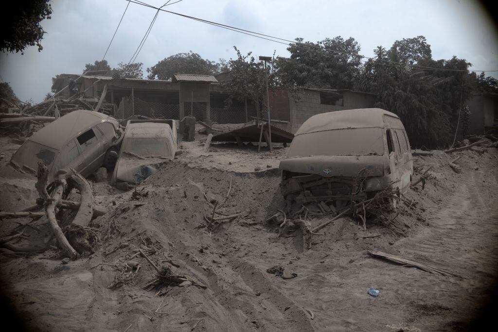 GUATEMALA CITY, GUATEMALA - JUNE 05: Cars are seen covered in ashes after the volcanic eruption in San Miguel Los Lotes village in Guatemala City, Guatemala on June 05, 2018. At least 69 people have been killed and many others were injured when the Fuego Volcano, 40 kilometers (25 miles) from the capital Guatemala City, erupted on Monday. (Photo by Fabricio Alonzo/Anadolu Agency/Getty Images)