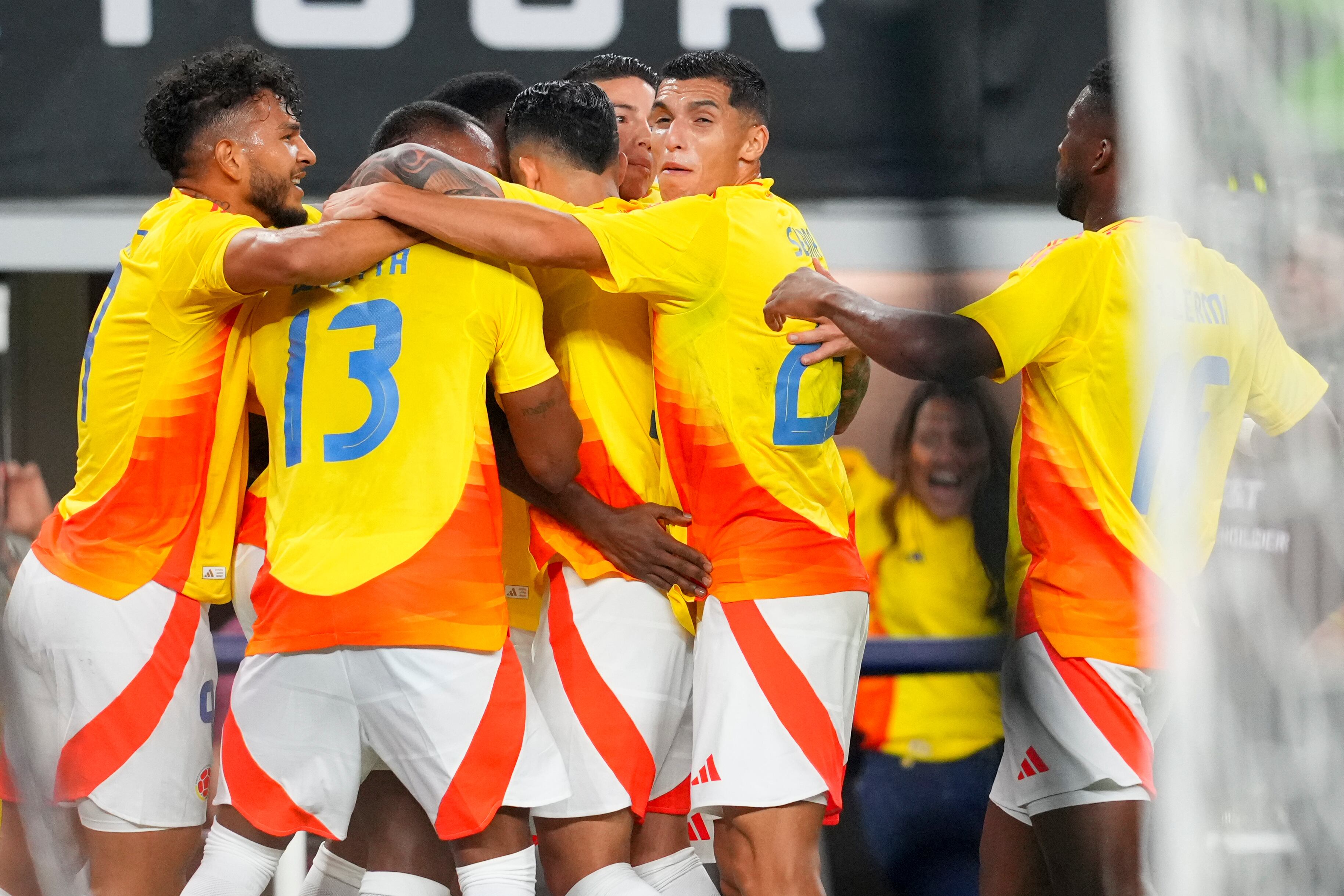Colombia players celebrate a goal by Colombia's Jhon Lucumí during the first half of an international soccer friendly match against Mexico Saturday, Oct. 11, 2025, in Arlington, Texas. (AP Photo/Julio Cortez)