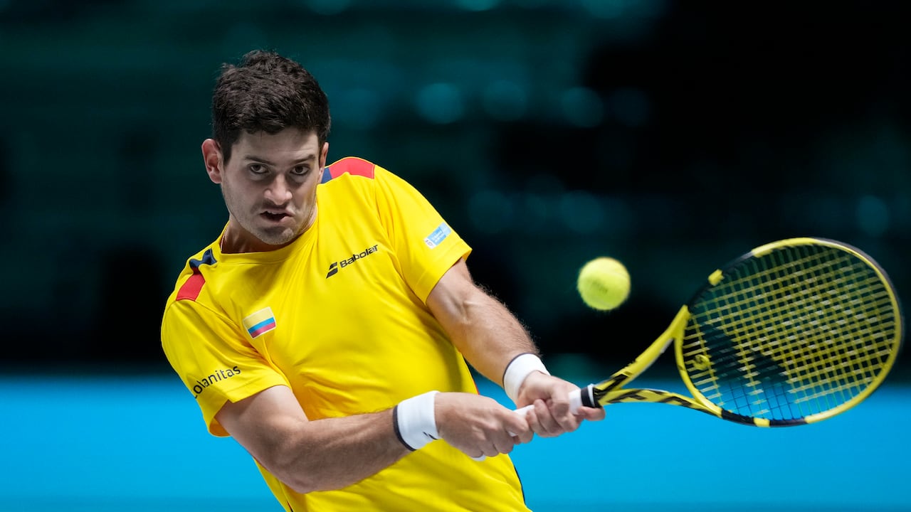 Colombia's Nicolas Mejia returns the ball to United States' Frances Tiafoe during their Davis Cup men's single Finals tennis match at the Pala Alpitour in Turin, Italy, Sunday, Nov. 28, 2021. (AP Photo/Antonio Calanni)