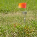 Flags and lights mark where ground-penetrating radar recorded hits of what are believed to be 751 unmarked graves in this cemetery near the grounds of the former Marieval Indian Residential School on the Cowessess First Nation, Saskatchewan, Canada. on Saturday, June 26, 2021. (Mark Taylor/The Canadian Press via AP)