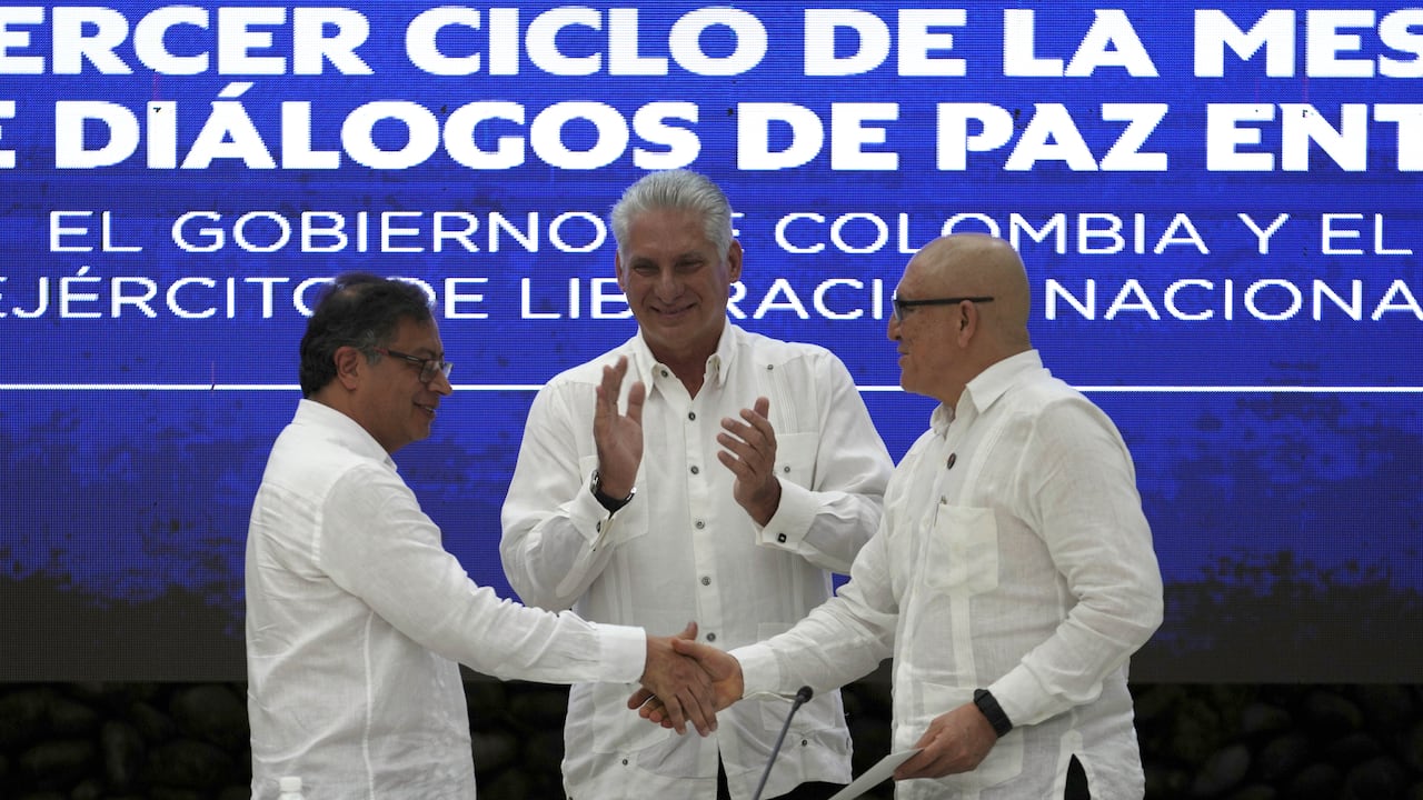Cuban President Miguel Diaz-Canel applauds as Colombia's President Gustavo Petro, left, and ELN commander Antonio Garcia shake hands during a bilateral ceasefire agreement signing ceremony between Petro's government and the Colombian National Liberation Army (ELN) guerrilla, at El Laguito in Havana, Cuba, Friday, June 9, 2023. (AP Photo/Ramon Espinosa)