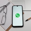 In this photo illustration a WhatsApp logo is displayed on a smartphone screen above a notebook next to glasses and a pen in Athens, Greece on June 29, 2023. (Photo by Nikolas Kokovlis/NurPhoto via Getty Images)