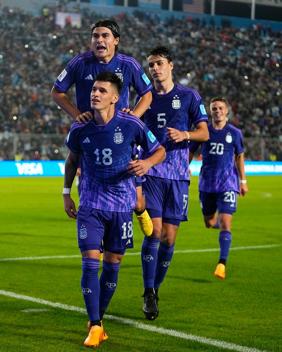 CORRECTS NUMBER OF GOALS SCORED - Argentina's Brian Aguirre (18) celebrates with his teammates after scoring his side's fourth goal against New Zealand during a FIFA U-20 World Cup Group A soccer match at the San Juan stadium in San Juan, Argentina, Friday, May 26, 2023. (AP Photo/Natacha Pisarenko)