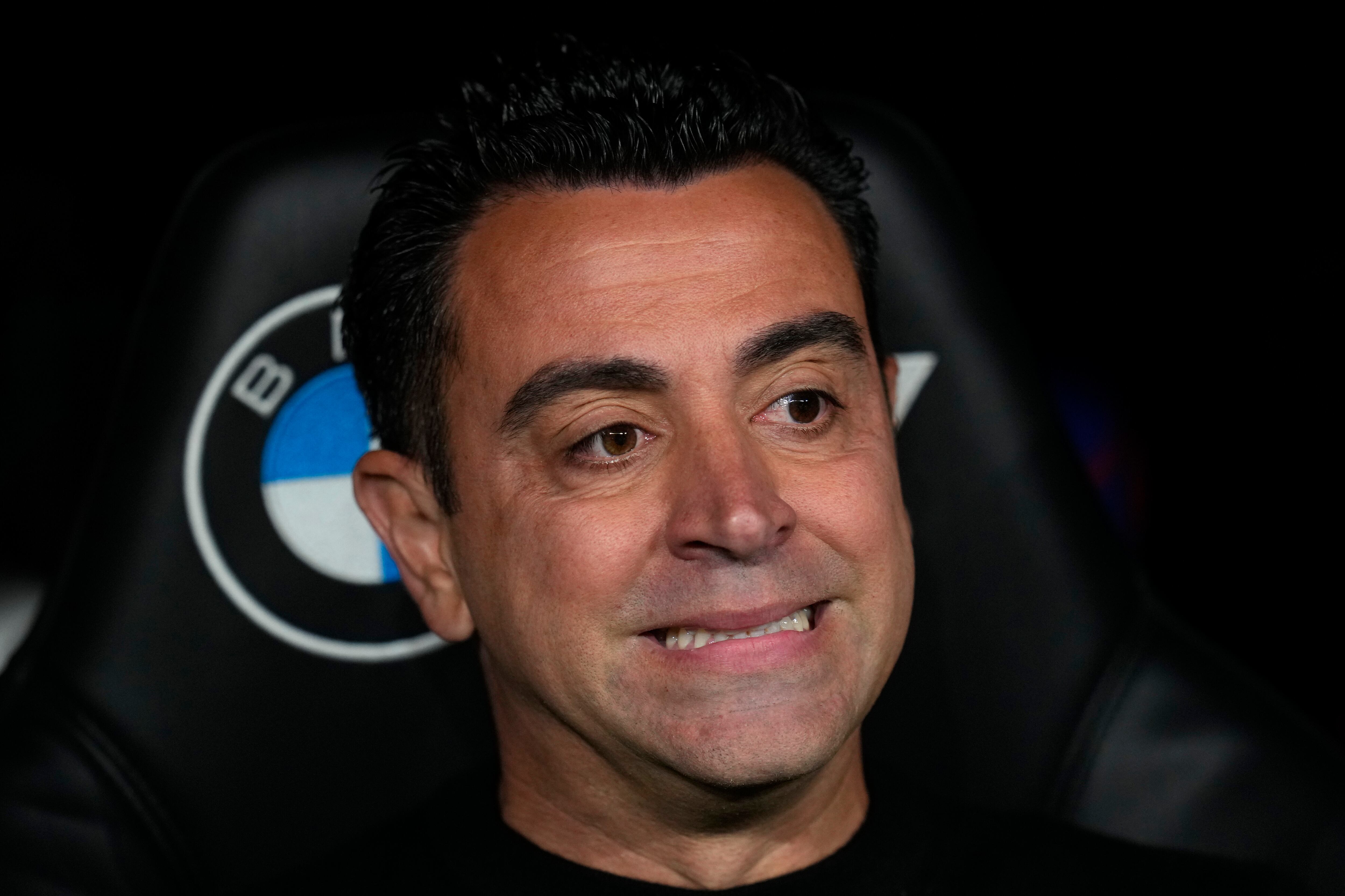 Barcelona's head coach Xavi Hernandez gestures as he attends the start of the Spanish La Liga soccer match between Real Madrid and Barcelona at the Santiago Bernabeu stadium in Madrid, Spain, Sunday, April 21, 2024. (AP Photo/Manu Fernandez)
