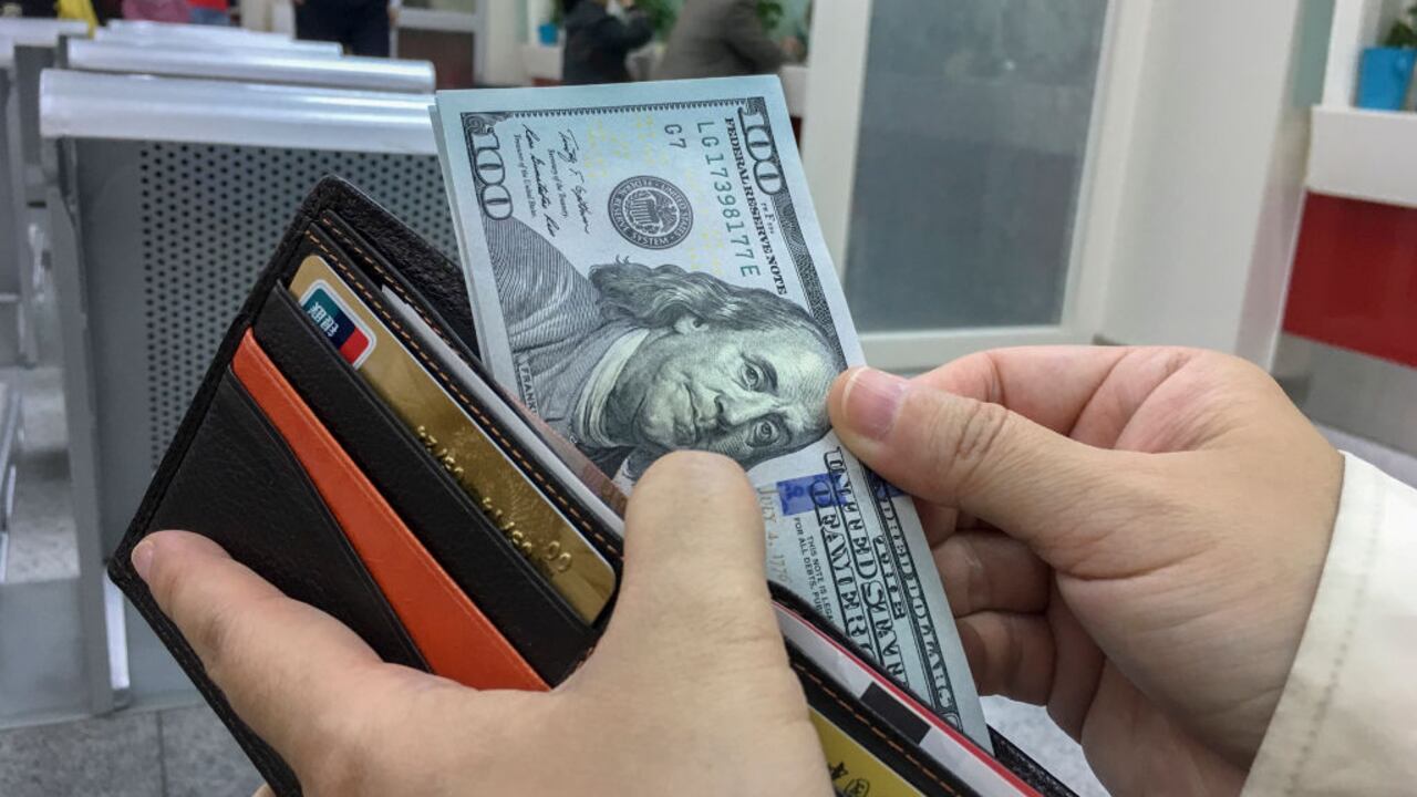 BEIJING, CHINA - 2017/04/18: A Chinese tourist exchange some US Dollar banknotes in a bank, preparing for a travel abroad.  According to the report of UNWTO,  Chinese mainland travelers have spent as high as $261.1 billion abroad,  an increase of 12% over the year of 2015, accounting for about 20.9% of total consumption.  The number of outbound tourists grew by 6%, reaching 135 million. (Photo by Zhang Peng/LightRocket via Getty Images)