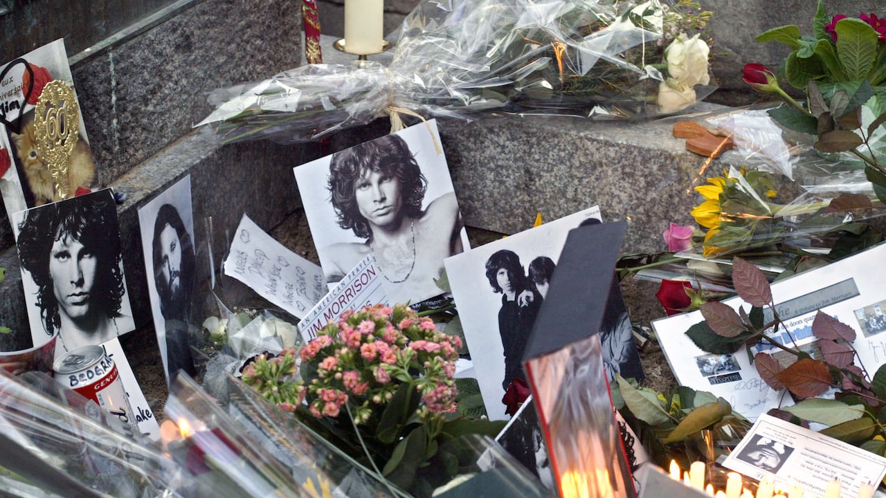 (FILES) This file photo taken on December 8, 2003 shows the grave of US rock legend Jim Morrison at the Perfe-Lachaise cemetery in Paris. - July 3, 2021 will mark the 50th anniversary of Doors frontman Jim Morrison's death at age 27. (Photo by Joel ROBINE / AFP)