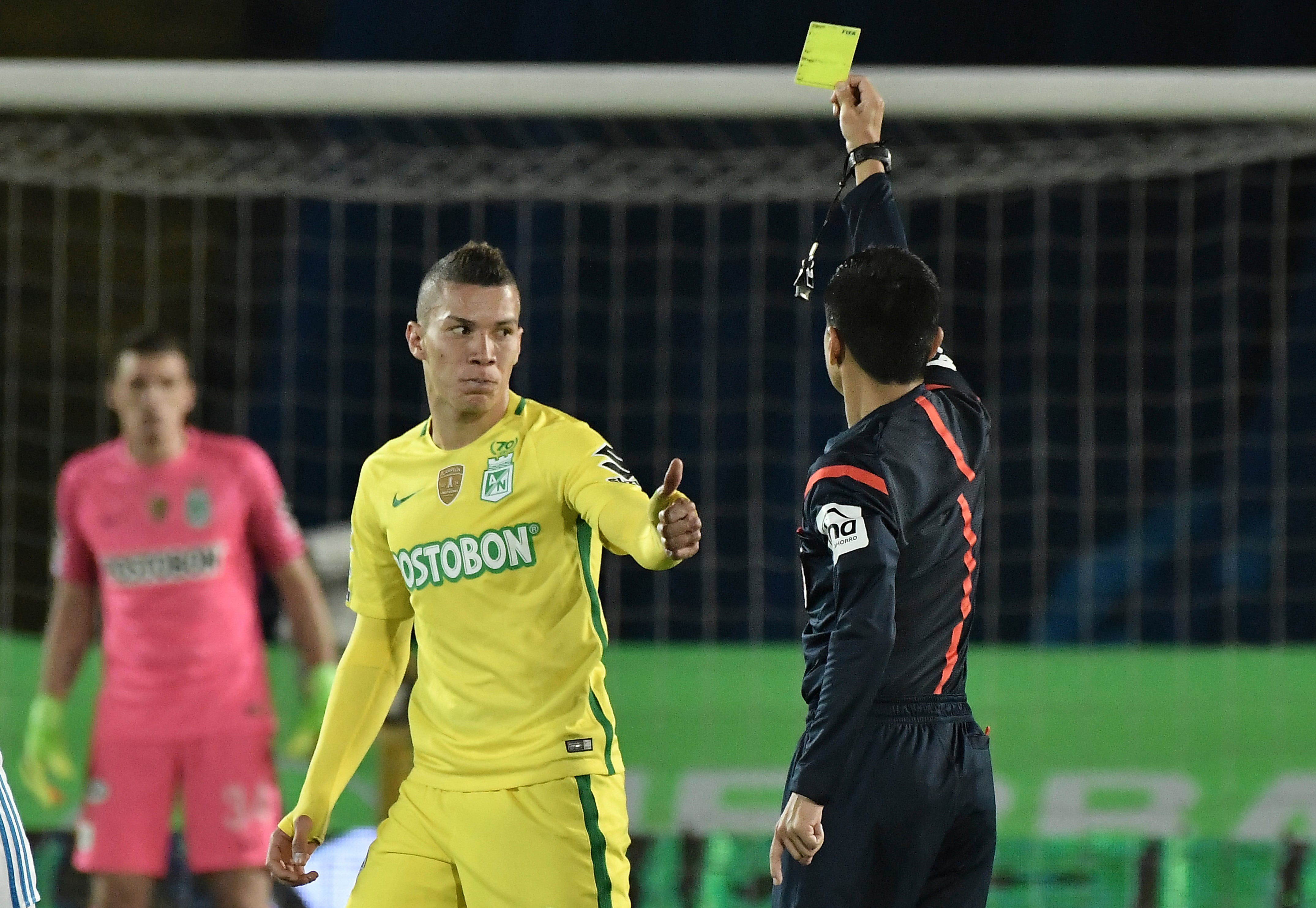 BOGOTA, COLOMBIA - JUNE 07: Referee Mario Herrera shows a yellow card to Matheus Uribe of Atletico Nacional during the Semi Finals first leg match between Millonarios and Atletico Nacional as part of Liga Aguila I 2017 at Nemesio Camacho Stadium on June 7, 2017 in Bogota, Colombia. (Photo by Gabriel Aponte/Vizzor/LatinContent via Getty Images)