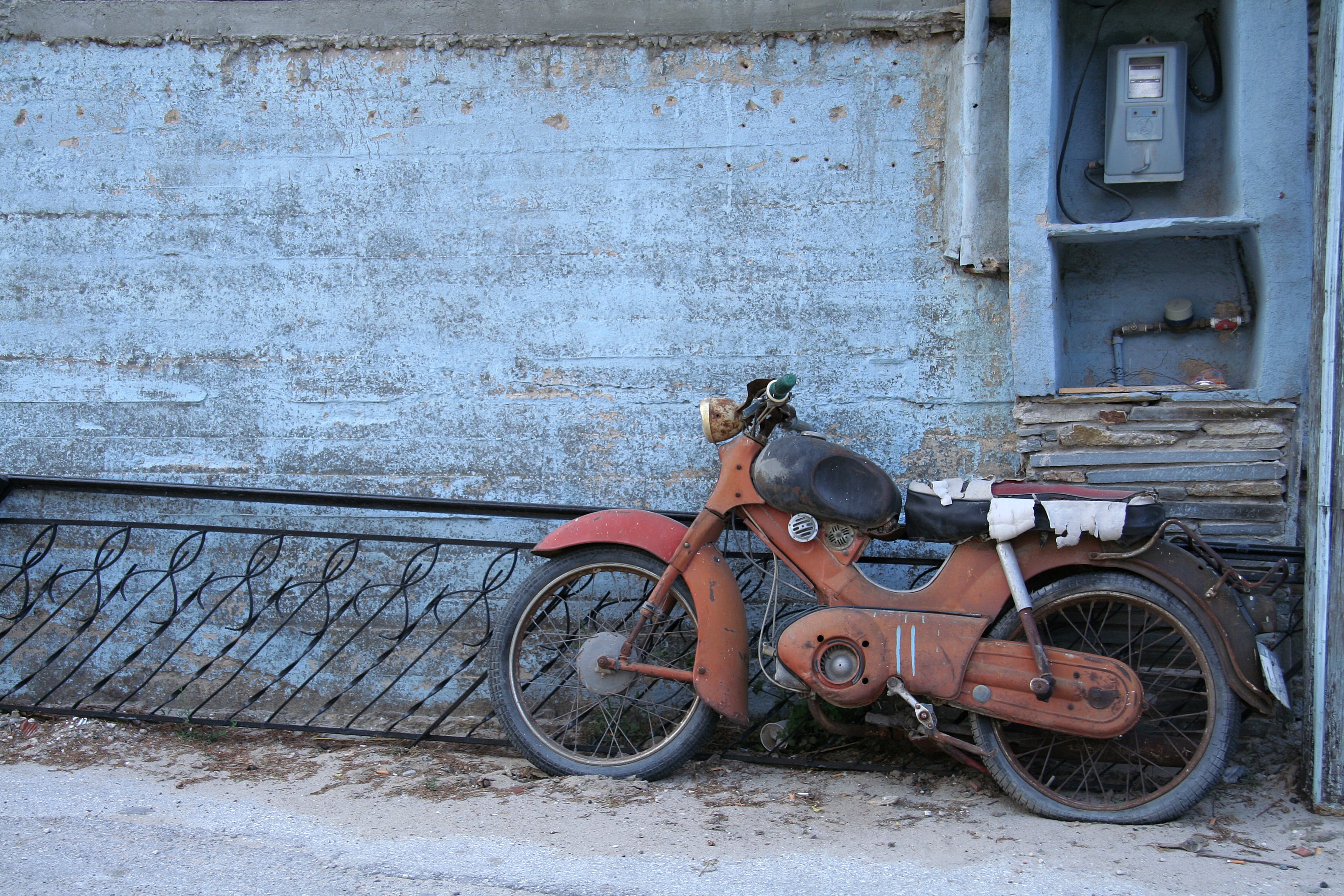 Worn-out motorbike in the village Maries on the island Thassos in Greece. Copyspace