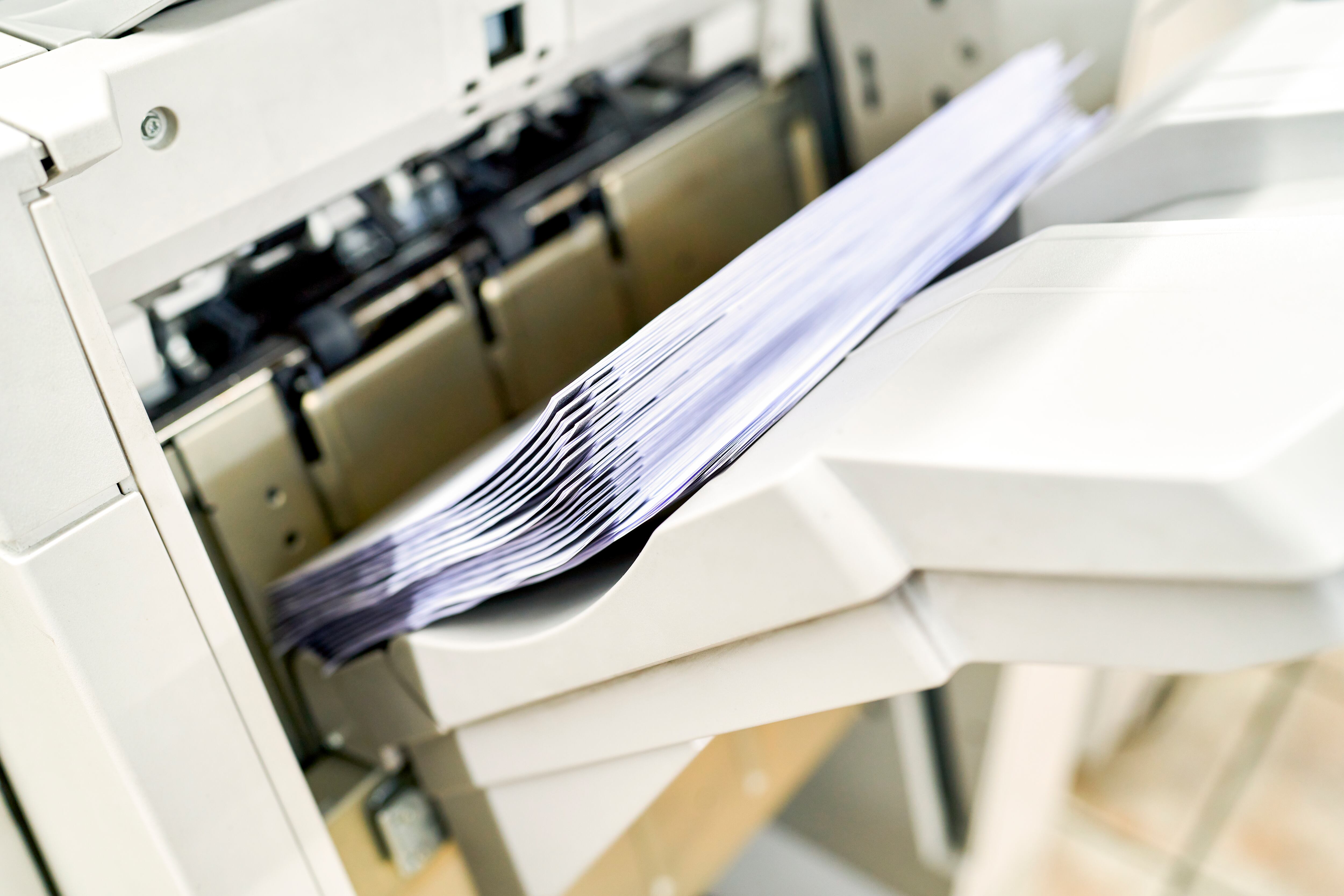 Close up view of sheets of paper inside printer in the stationery store
