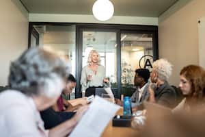 Businesswoman talking to her colleagues on presentation in the office