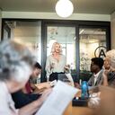 Businesswoman talking to her colleagues on presentation in the office