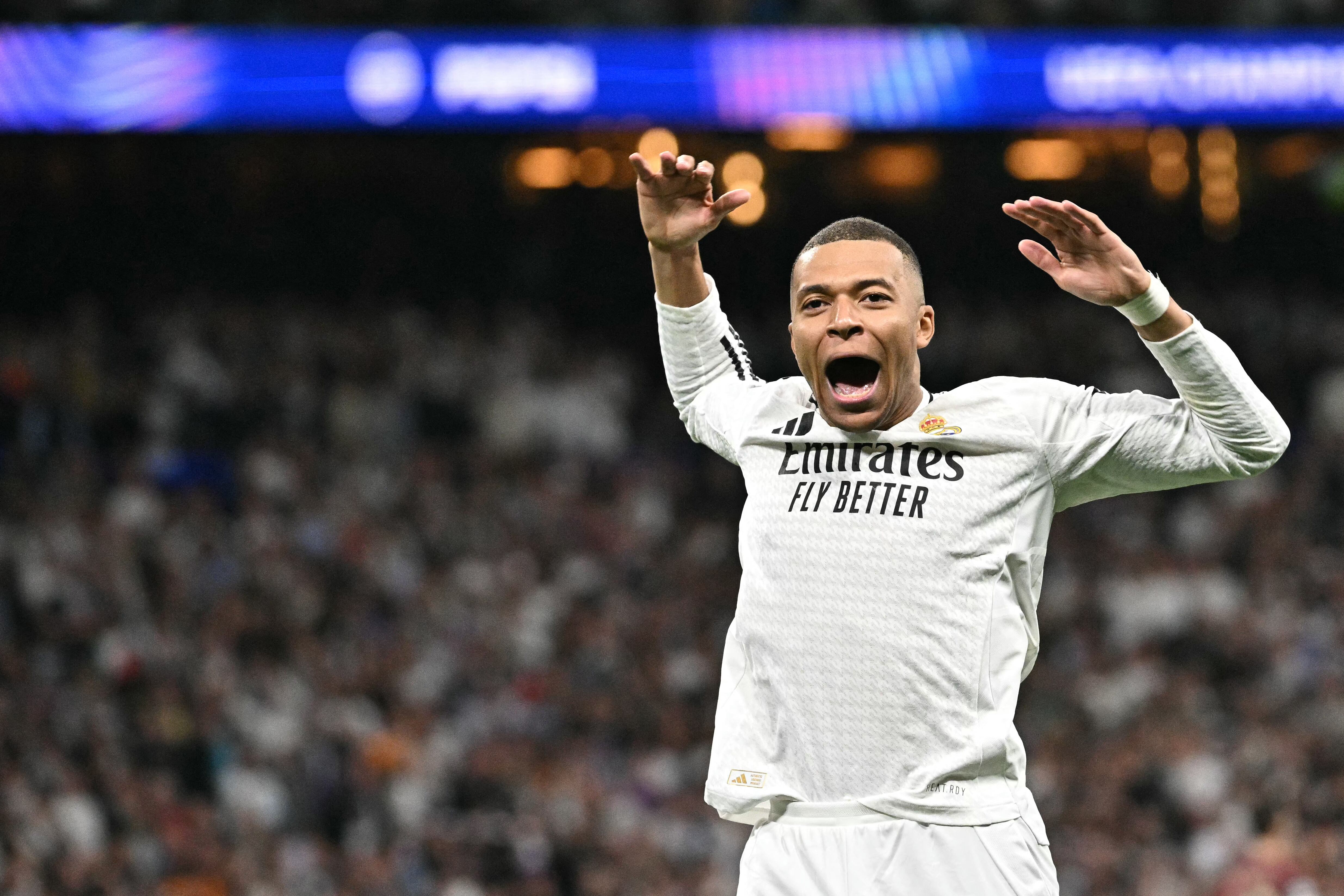 Real Madrid's French forward #09 Kylian Mbappe celebrates scoring his second goal during the UEFA Champions League knockout phase play-off football match between Real Madrid CF and Manchester City at the Santiago Bernabeu stadium in Madrid on February 19, 2025. (Photo by JAVIER SORIANO / AFP)