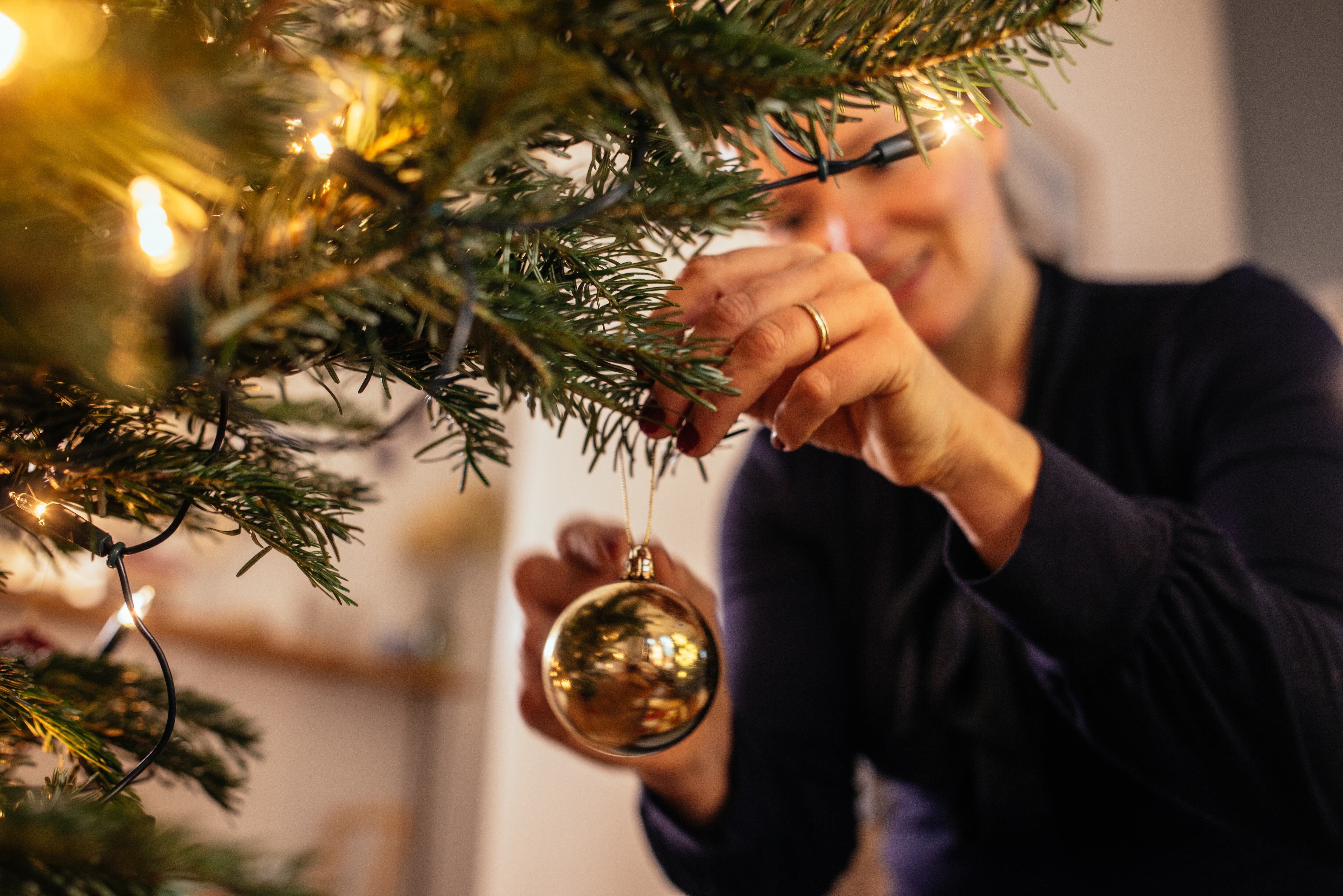 Mujer decorando el árbol de Navidad