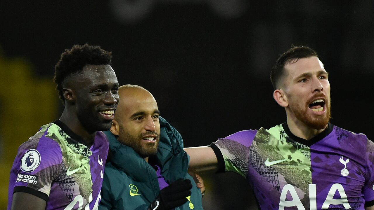 Tottenham's Davinson Sanchez, left, Lucas Moura, center, and Pierre-Emile Hojbjerg celebrate at the end of the English Premier League soccer match between Watford and Tottenham Hotspur at Vicarage Road, Watford, England, Saturday, Jan. 1, 2022. (AP Photo/Rui Vieira)