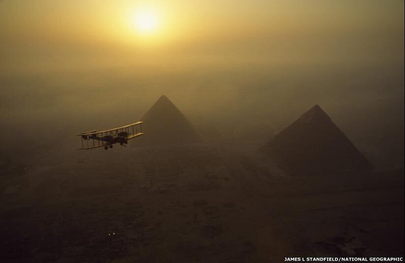 La réplica del avión Vickers Vimy vuela sobre las pirámides de Giza, en Egipto, para recrear el histórico vuelo de Londres a Australia que se llevó a cabo en 1919. El autor de esta imagen es James L Stansfield. (Foto original de NatGeo / Tomada de BBC Mundo).