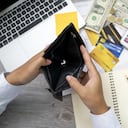 poor Asian woman hand open empty purse looking for money having problem bankrupt broke after credit card payday