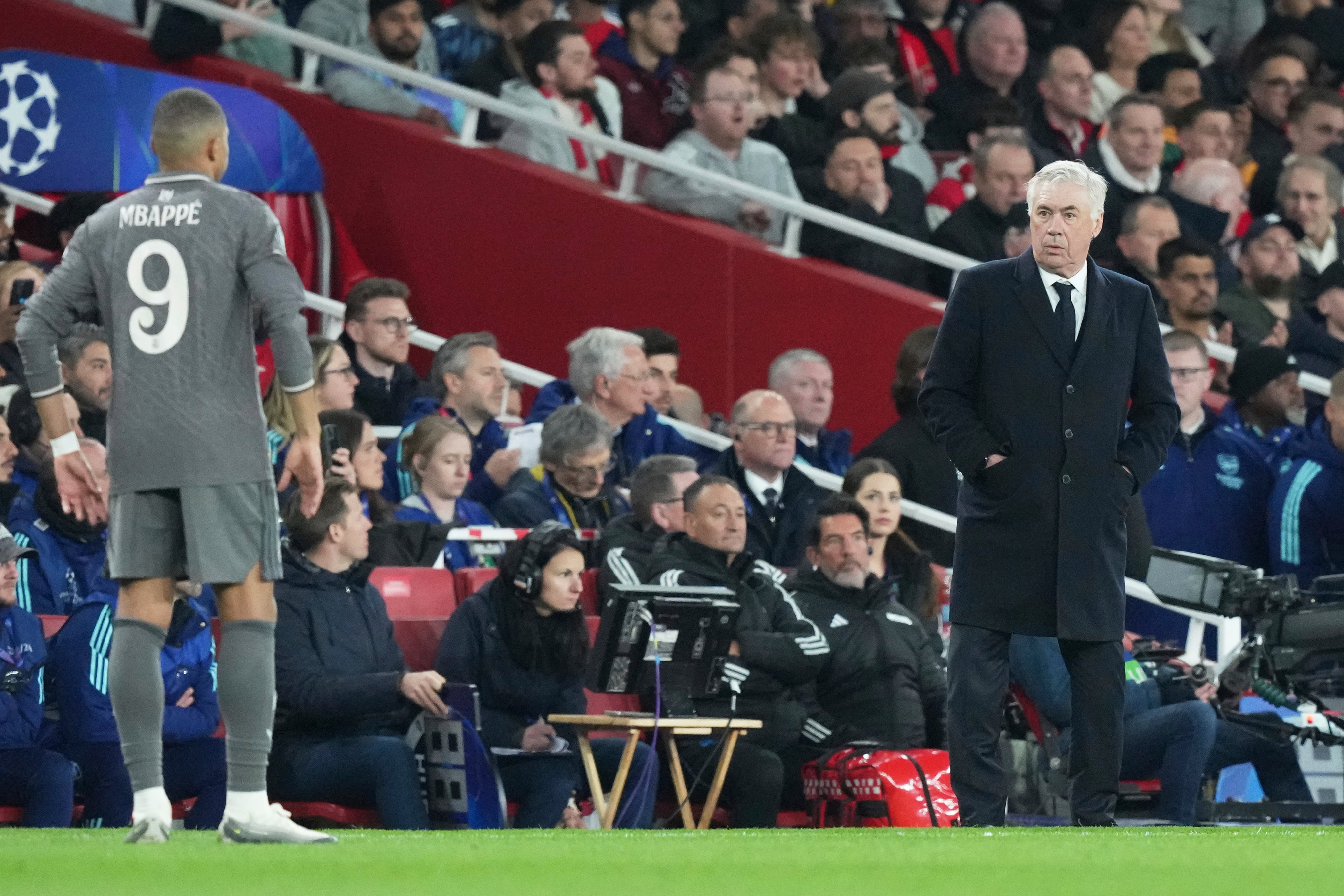 Real Madrid's head coach Carlo Ancelotti, right, and Real Madrid's Kylian Mbappe react end of the Champions League quarterfinal first leg soccer match between Arsenal and Real Madrid at the Emirates Stadium in London, Tuesday, April 8, 2025. (AP Photo/Frank Augstein)