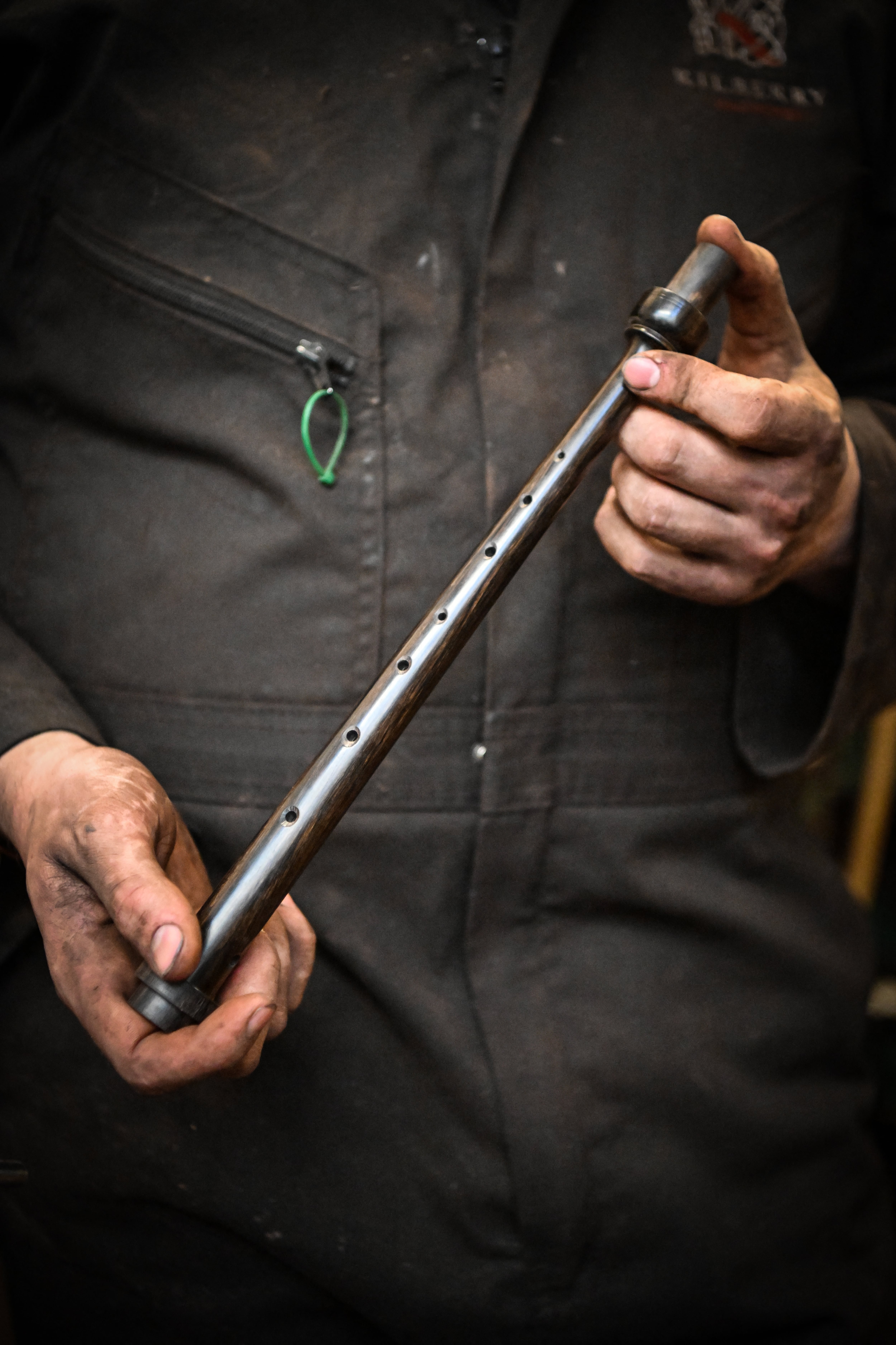 Artisan bagpipe maker Ruari Black, the last traditional bagpipe-makers who make everything by hand from start to finish, works on a bagpipe chanter in the workshop of Kilberry Bagpipes in Edinburgh, on October 7, 2024. The Highland bagpipe is an integral part of Scottish culture and history, famous for its distinctive, powerful sound that even accompanied troops as they landed in northern France on D-Day. But the wind instrument is slowly growing silent as demand dwindles and machine-made bagpipes replace traditionally crafted ones, consigning their use to largely ceremonial occasions. Ruari Black is one of only a few remaining craftsmen in Edinburgh who knows how to make the instrument by hand. (Photo by ANDY BUCHANAN / AFP)