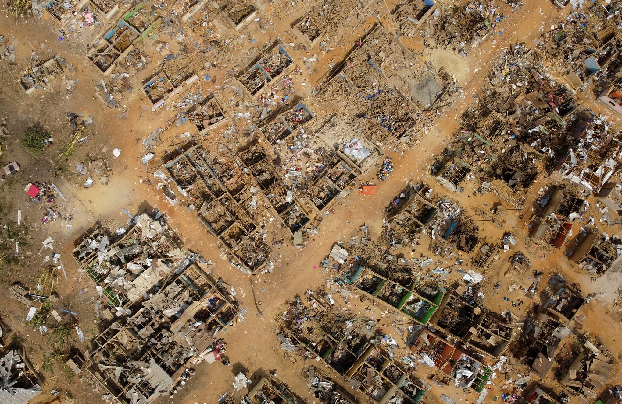 La gente observa los daños causados cuando un vehículo que transportaba explosivos mineros detonó a lo largo de una carretera en Apiate, Ghana. Foto REUTERS/Francis Kokoroko