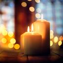 Candles burning in a church background