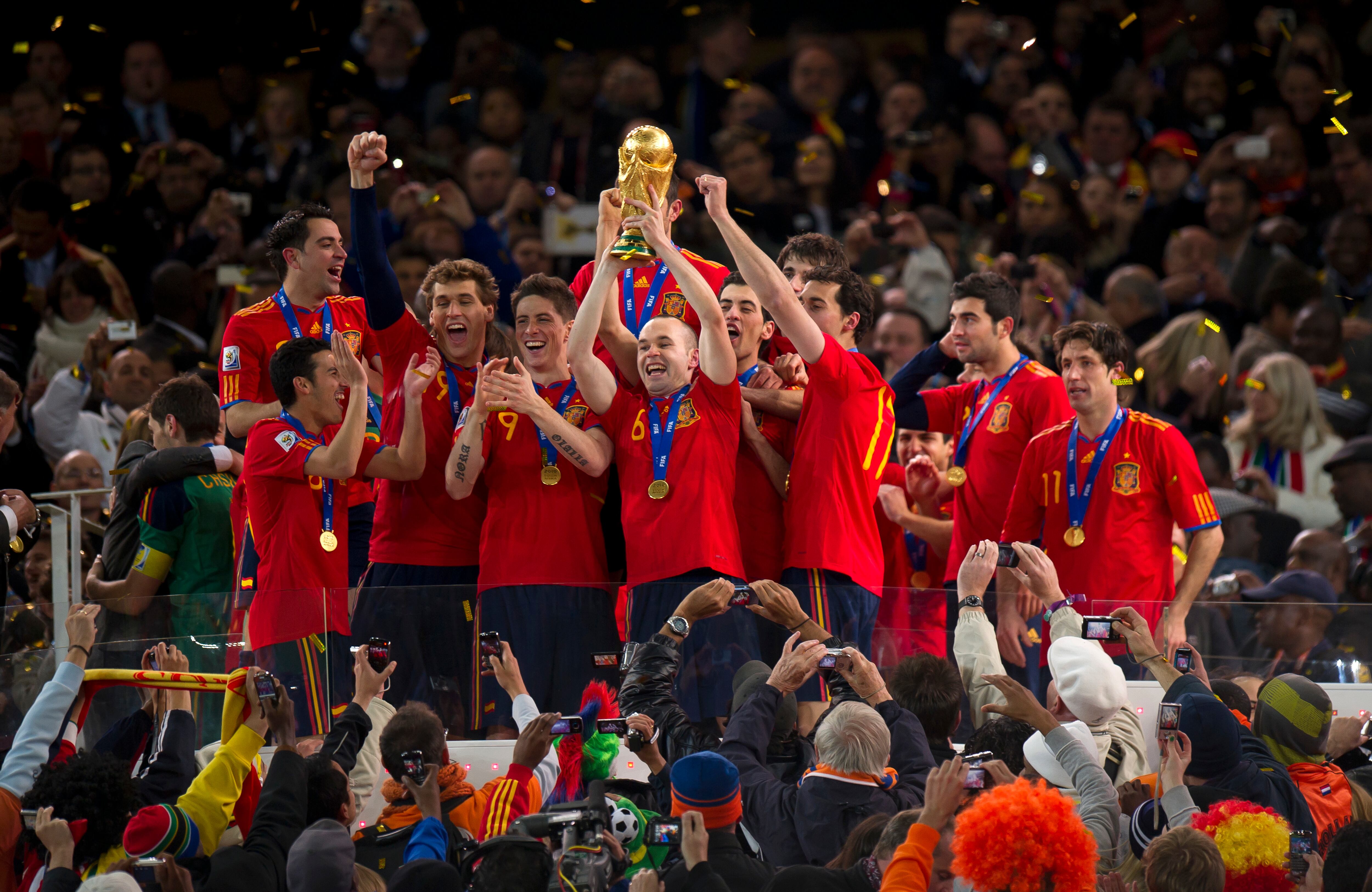 Scorer of the winning goal, Andres Iniesta of Spain holds up the FIFA World Cup Trophy (Photo by AMA/Corbis via Getty Images)