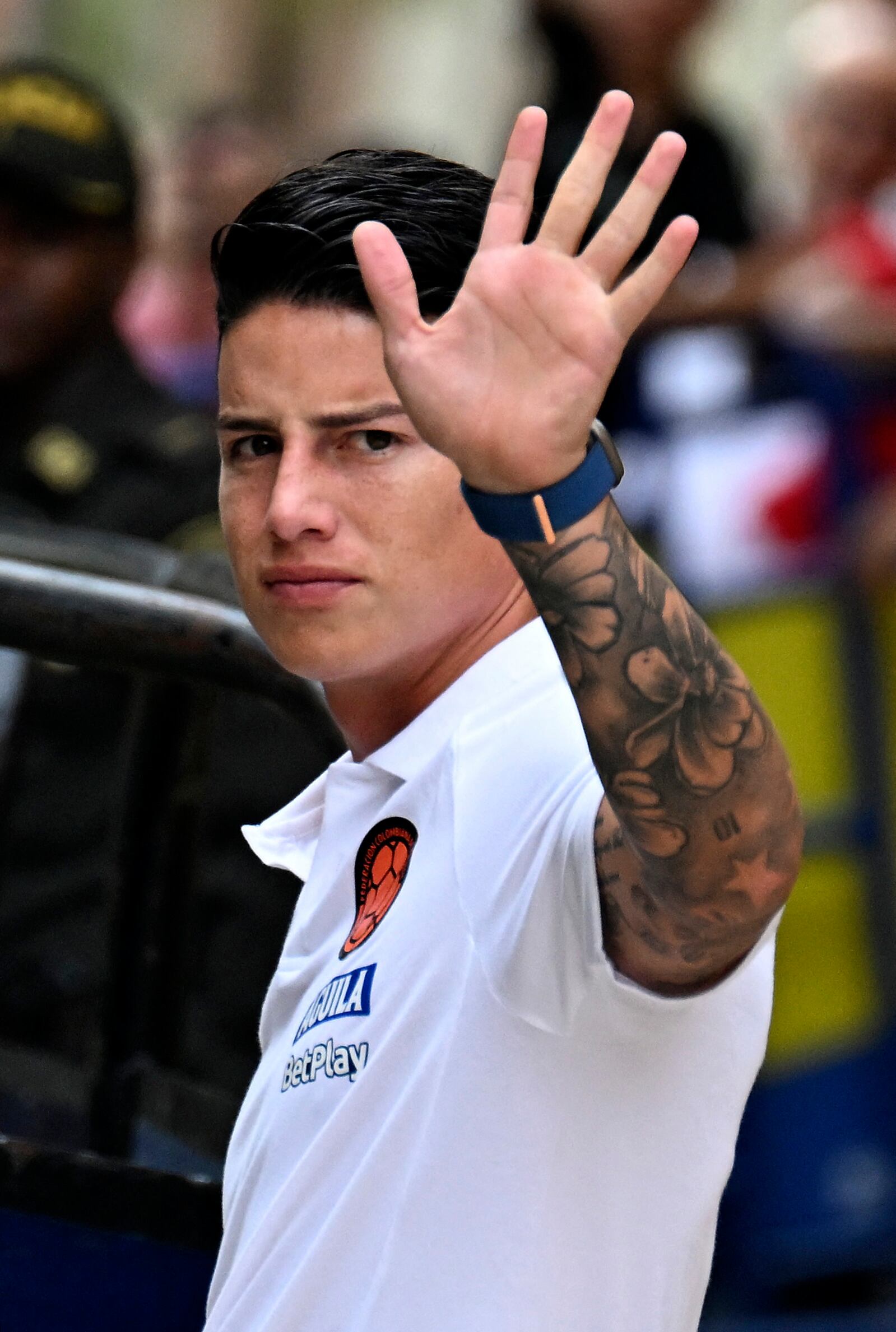 Colombian midfielder James Rodriguez waves to fans while heading to a practice session in Barranquilla, Colombia, on September 8, 2024. Colombia will face Argentina next September 10 for the FIFA South American qualifiers. (Photo by JOAQUIN SARMIENTO / AFP)