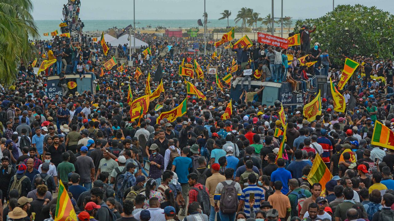 Protestors demanding the resignation of Sri Lanka's President Gotabaya Rajapaksa gather near the compound of Sri Lanka's Presidential Palace in Colombo on July 9, 2022. - Sri Lanka's beleaguered President Gotabaya Rajapaksa fled his official residence in Colombo, a top defence source told AFP, before protesters gathered to demand his resignation stormed the compound. (Photo by AFP)