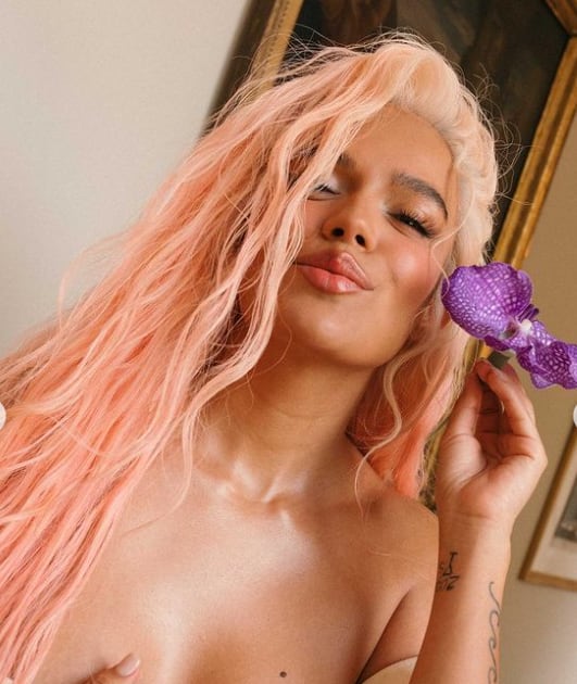 La cantante Karol G posando con sensual vestido blanco.