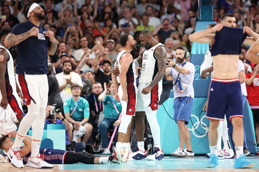 PARIS, FRANCE - AUGUST 08: Lebron James #6 and Stephen Curry #4 of Team United States celebrate after winning a Men's basketball semifinals match between Team United States and Team Serbia on day thirteen of the Olympic Games Paris 2024 at Bercy Arena on August 08, 2024 in Paris, France. (Photo by Ezra Shaw/Getty Images)