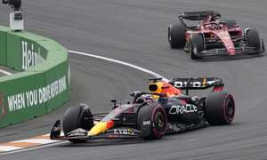 Red Bull driver Max Verstappen of the Netherlands leads Ferrari driver Charles Leclerc of Monaco, right, during the Formula One Dutch Grand Prix auto race, at the Zandvoort racetrack, in Zandvoort, Netherlands, Sunday, Sept. 4, 2022. (AP Photo/Peter Dejong)
