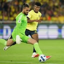 Colombia's goalkeeper Alvaro Montero, left, fights for the ball with Ecuador's Kevin Rodriguez during a qualifying soccer match for the FIFA World Cup 2026 at the Rodrigo Paz Delgado stadium in Quito, Ecuador, Tuesday, Oct. 17, 2023. (AP Photo/Dolores Ochoa)