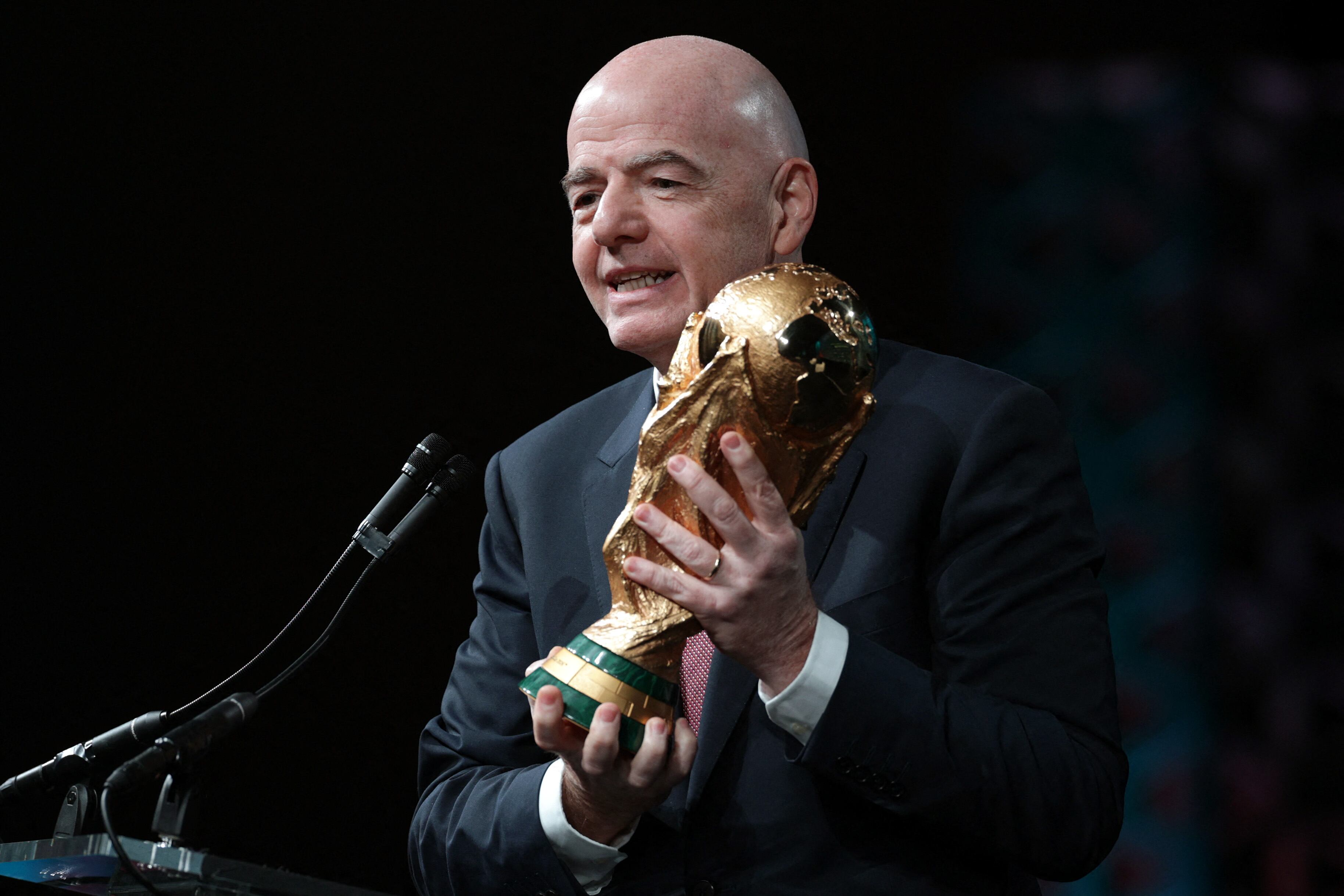 WASHINGTON, DC - JANUARY 29: FIFA President Gianni Infantino holds the FIFA World Cup Trophy as he addresses the winter meeting of The U.S. Conference of Mayors on January 29, 2026 in Washington, DC. Infantino promoted the 2026 FIFA World Cup, which will be co-hosted by the United States, Canada, and Mexico, highlighting its potential benefits for host cities and communities. Alex Wong/Getty Images/AFP (Photo by ALEX WONG / GETTY IMAGES NORTH AMERICA / Getty Images via AFP)