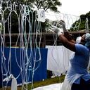 A health worker dries decontaminated nasal prongs and oxygen face masks at Queen Elizabeth Central Hospital in Blantyre, Malawi on Saturday, Jan. 30, 2021. Malawi faces a resurgence of COVID-19 that is overwhelming the southern African country where a presidential residence and a national stadium have been turned into field hospitals in efforts to save lives. (AP Photo/Thoko Chikondi)