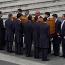 Pope Francis sits in a wheelchair as the coffin of late Pope Emeritus Benedict XVI is carrying after a funeral mass at St. Peter's Square at the Vatican, Thursday, Jan. 5, 2023. Benedict died at 95 on Dec. 31 in the monastery on the Vatican grounds where he had spent nearly all of his decade in retirement, his days mainly devoted to prayer and reflection. (AP Photo/Antonio Calanni)