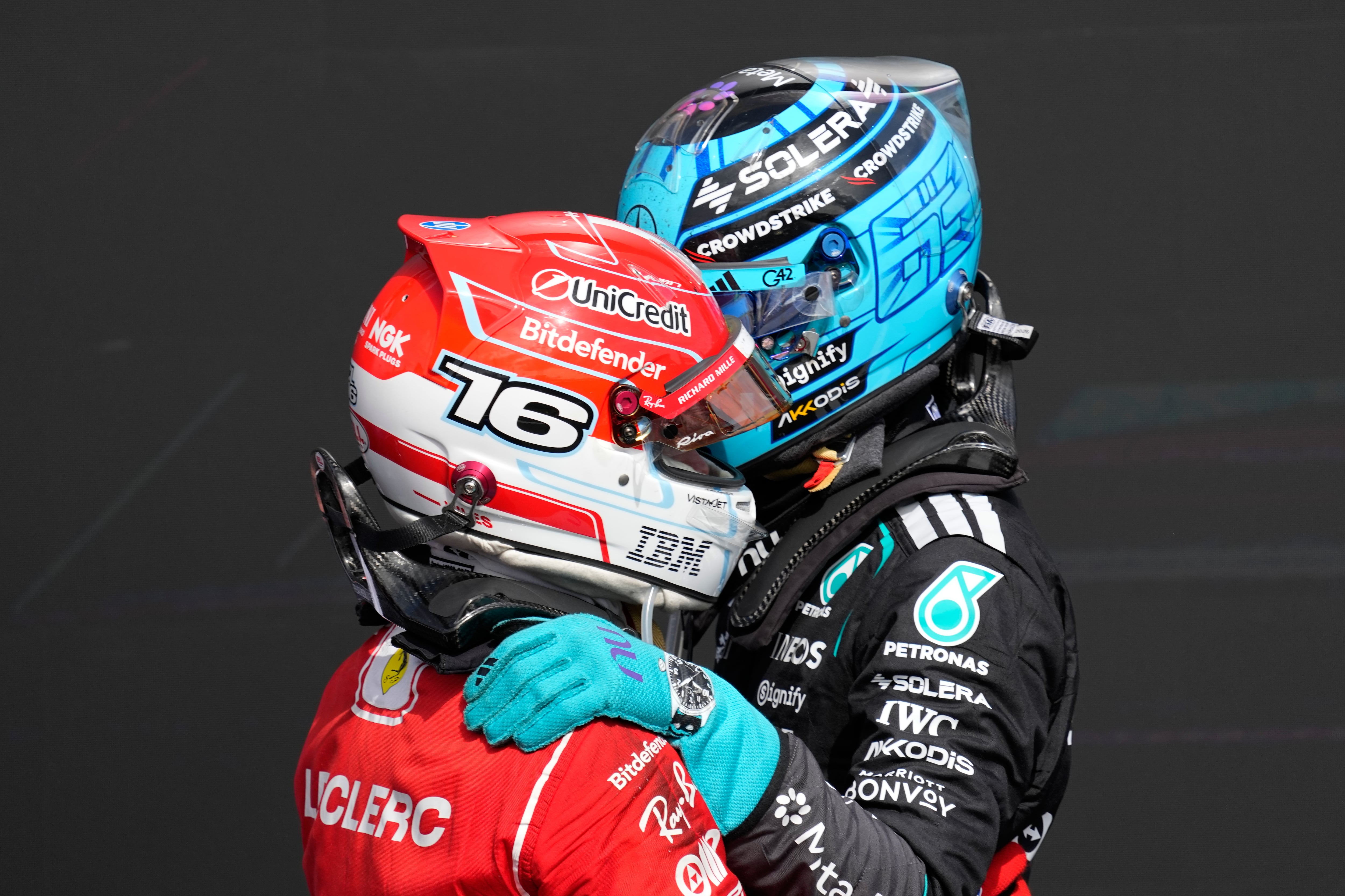 Race winner Ferrari driver Charles Leclerc of Monaco, front, celebrates with second placed Mercedes driver George Russell of Britain after the British F1 Grand Prix, in Silverstone, England, Sunday, July 5, 2026. (AP Photo/Darko Bandic)