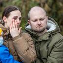 Yana (L) and Serhiy Shapoval (R) speak during an interview with AFP, with their five-year-old son Leonid, who suffers from leukaemia, in front of their new home in Ballydehob, near Cork, south west Ireland, on March 7, 2022 after fleeing Ukraine following Russia's invasion of the country. - The Shapovals escaped the war in Ukraine after doctors urged the parents of Leonid to leave the country on March 3, 2022, telling them there was no more they could do for their son. Yana and Serhiy have since learnt that the hospital, where Leonid received his chemotherapy in Kyiv, has been bombed by Russian forces. Five-year-old Leonid is now being treated in Ireland for his condition. (Photo by PAUL FAITH / AFP)
