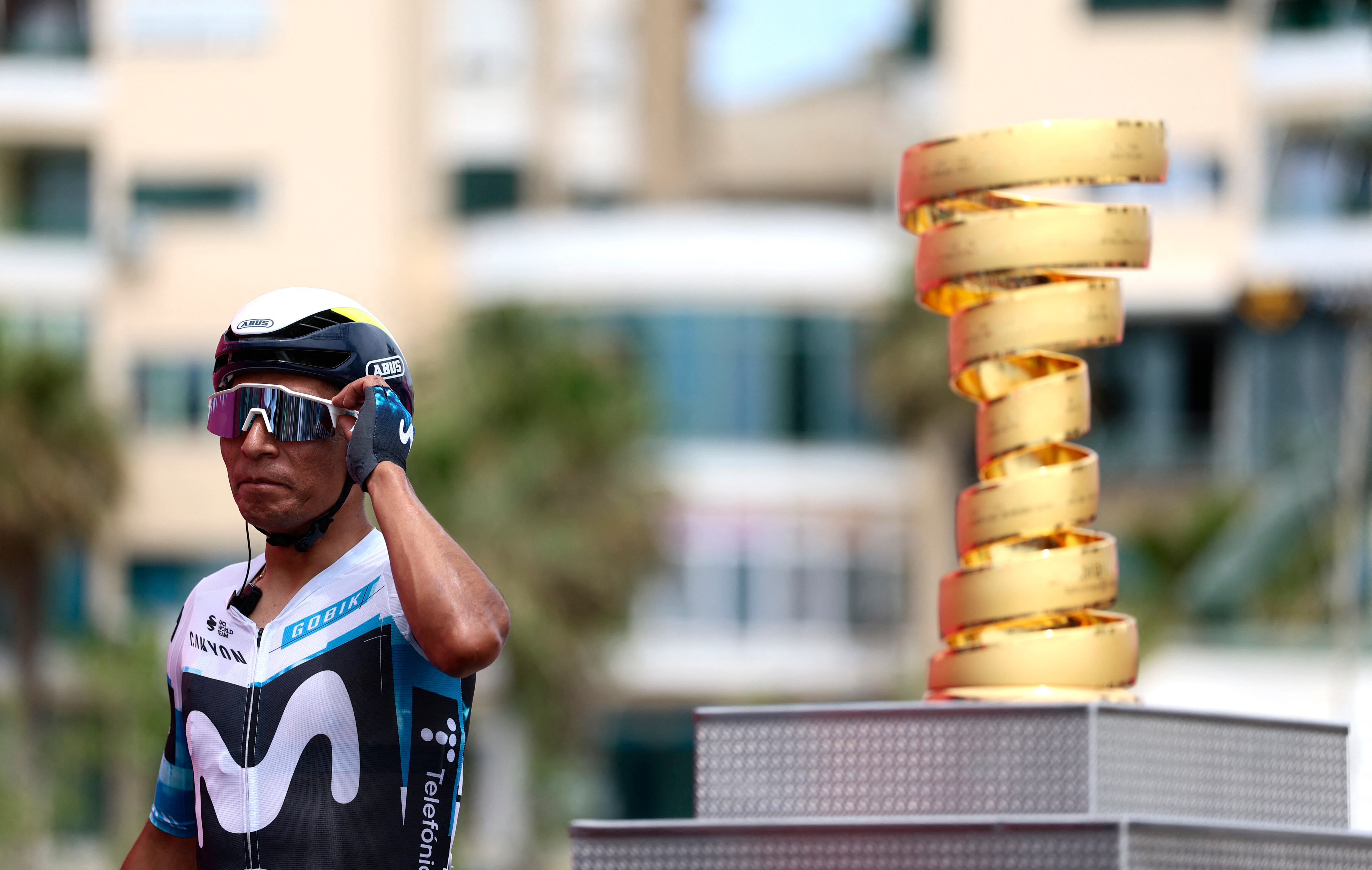 Movistar Team's Colombian rider Nairo Quintana walks past the Giro d'Italia trophy (�trofeo senza fine�) prior to the first stage of the 108th Giro d'Italia cycling race, 160km from Durres to Tirana in Albania, on May 9, 2025. (Photo by Luca Bettini / AFP)