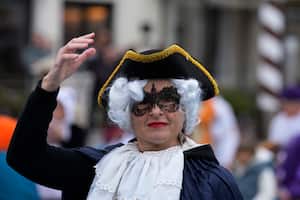 Una mujer enmascarada se sube a una góndola durante el desfile acuático, parte del Carnaval de Venecia, en Venecia, Italia, el domingo 5 de febrero de 2023.