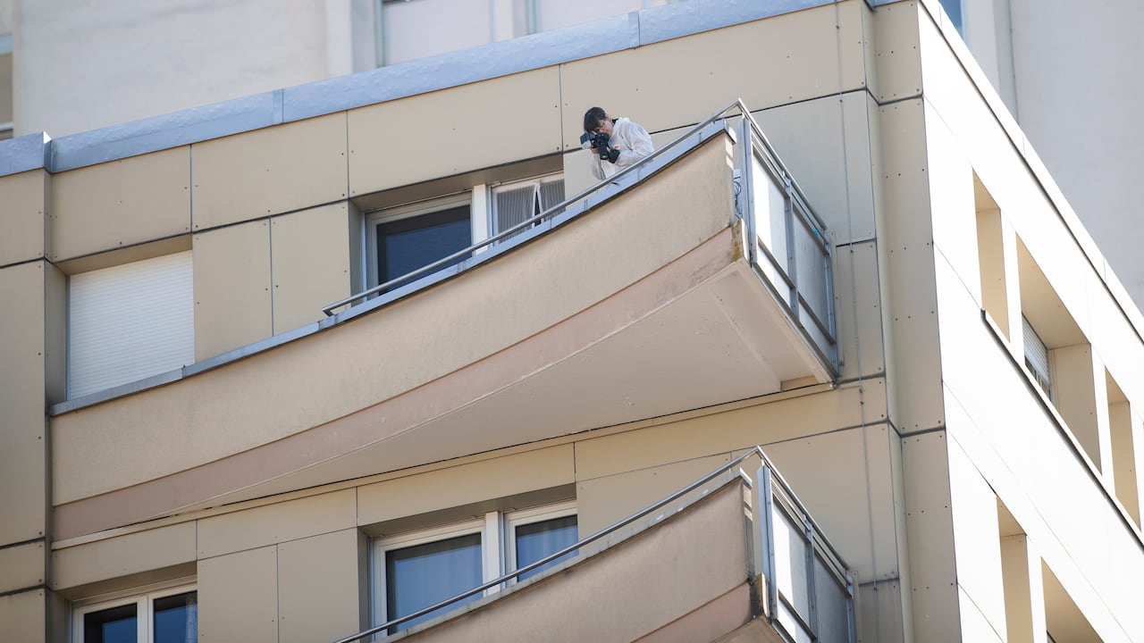 Un policía forense inspecciona la escena desde el balcón de un edificio de apartamentos en Montreux, Suiza.