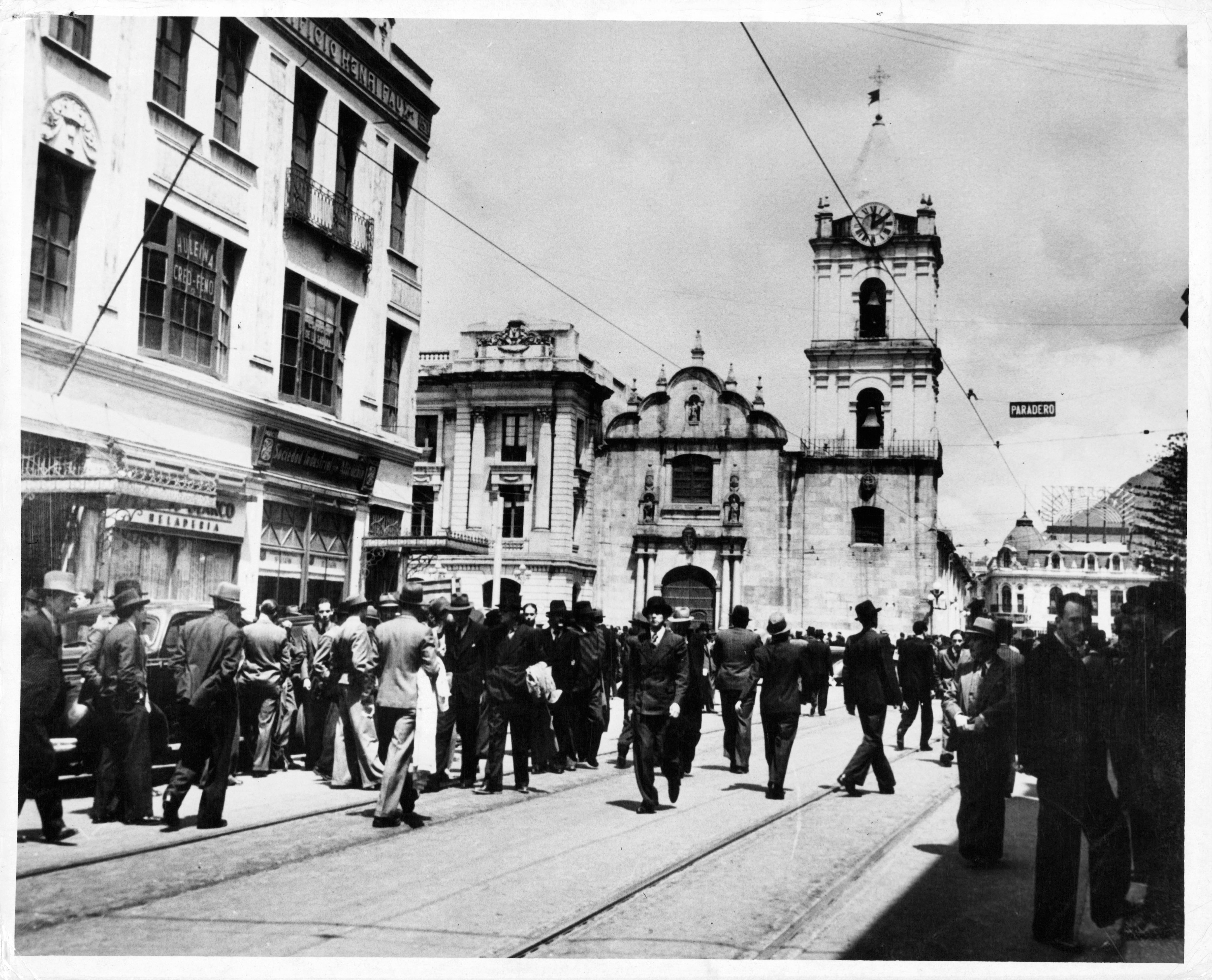 A view of men in suits walk the streets in Bogotá, Columbia. (Photo by Herbert/Archive Photos/Getty Images)